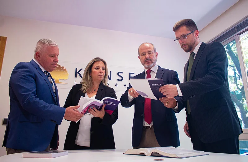 Lawyers reviewing financial documents during an international tax advisory meeting for cross-border matters in Spain