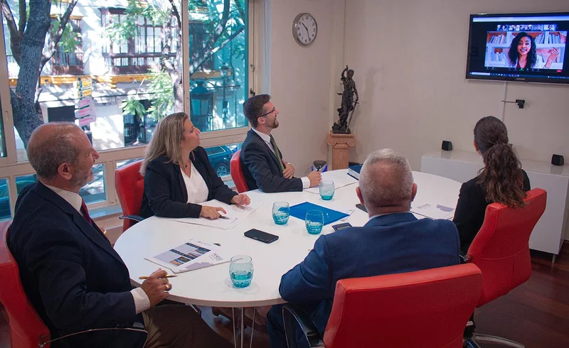 Legal advisors discussing strategic legal and tax matters with international clients in Spain